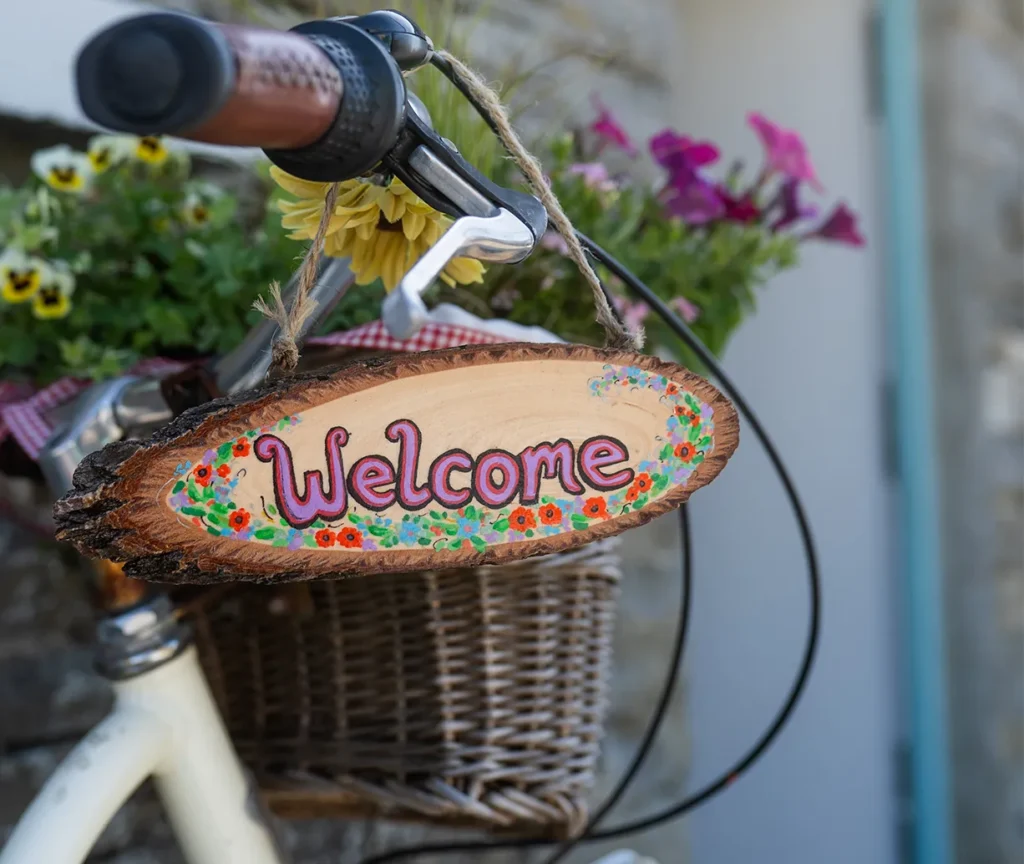 Bike handle close up with welcome sign hanging