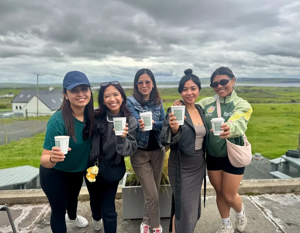 Group of friends show off their coffees