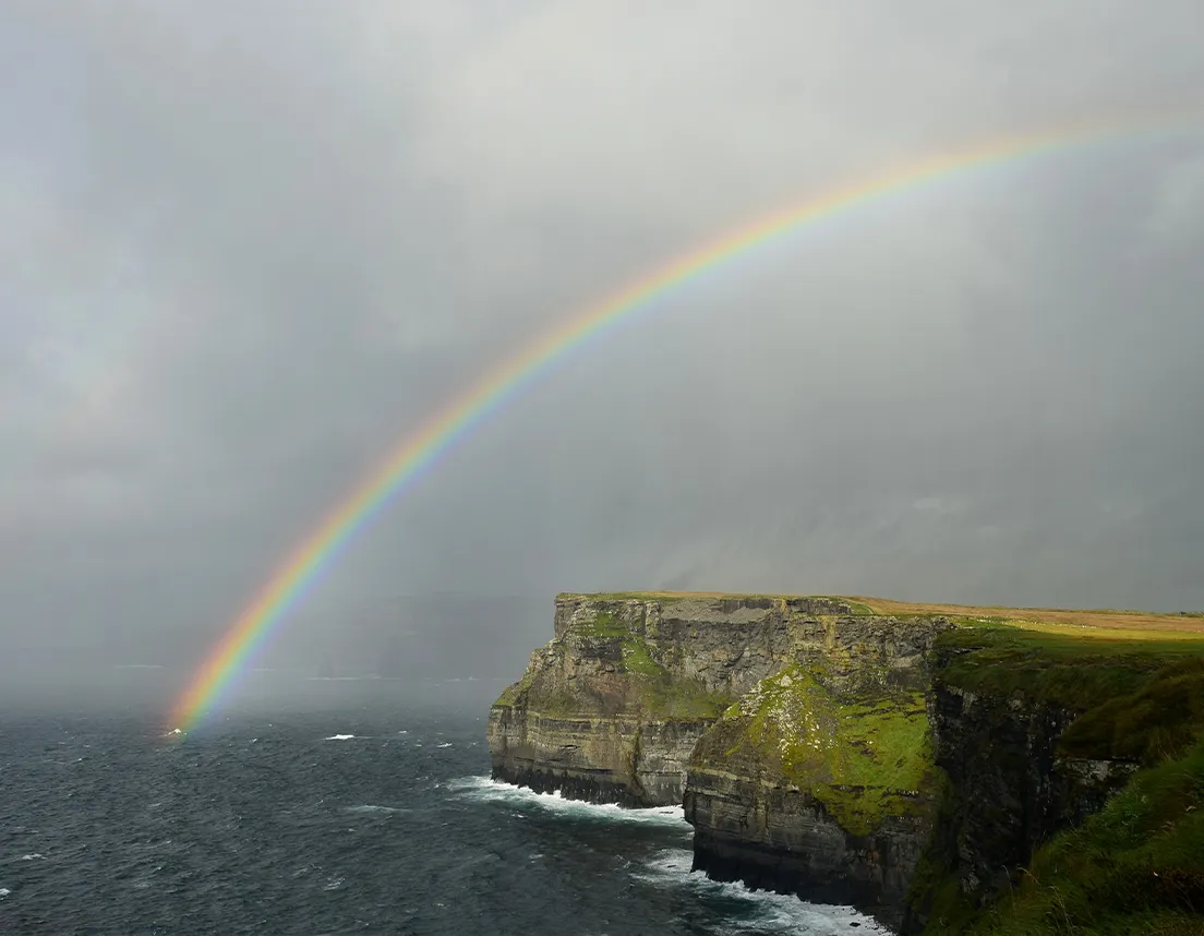 Rainbow over cliffs