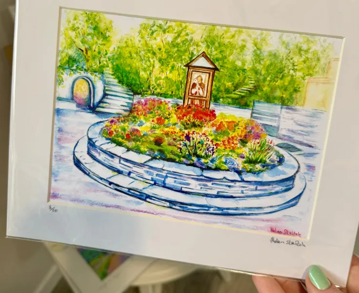 hand holding framed watercolour