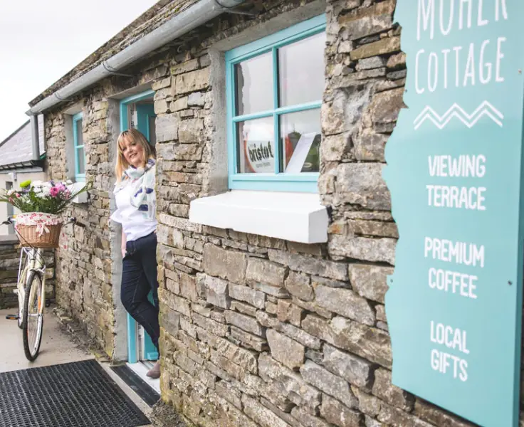 woman standing in doorway of moher cottage